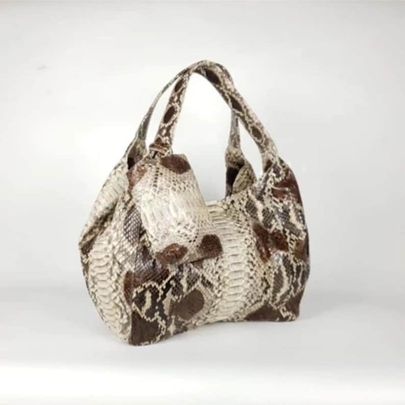 Model wearing the Genuine White Brown Python Leather Shoulder Bag, walking down the street with a confident and chic look. The bag adds a sophisticated touch to any outfit, perfect for both day and evening wear.