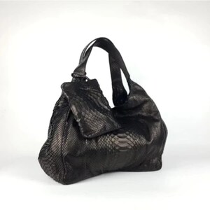 Luxury Genuine Black Python Leather Shoulder Bag with unique natural snake skin patterns and gold hardware, displayed elegantly on a clean white background, showcasing the rare and exotic beauty of real python leather.