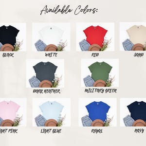 May include: A product display showcasing t-shirts in various colors: black, white, red, sand, dark heather, military green, light pink, light blue, royal, and navy. Each shirt is paired with denim shorts, a brown hat, and floral accents. Text reads "Available Colors:"