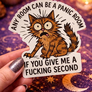 May include: A sticker featuring a cartoon cat with wide eyes and a panicked expression. The sticker reads "ANY ROOM CAN BE A PANIC ROOM IF YOU GIVE ME A FUCKING SECOND."