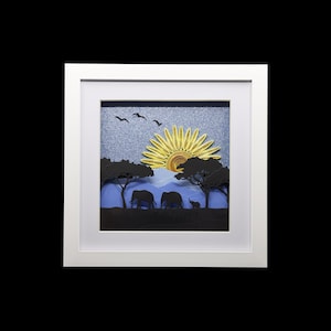 May include: A framed paper art piece depicting a sunset over a savanna with three elephants walking in silhouette. The sun is a yellow paper swirl with a red centre. The sky is blue with a sparkly texture. The trees are green and the ground is black.