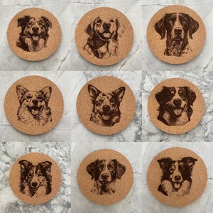 May include: Set of 10 cork coasters featuring different dog breeds. Each coaster has a brown wood-like finish with a laser-etched image of a dog.