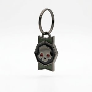 Llavero con medalla de guerra de resina que brilla en la oscuridad de Helldivers 2