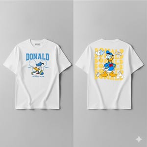 May include: White t-shirts with Donald Duck designs. The front displays "DONALD" in blue, with a cartoon Donald Duck image. The back features a Donald Duck cartoon and yellow text. A classic cartoon character.