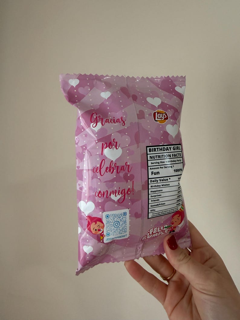 May include: A pink Lays potato chip bag with a heart pattern and the words "Gracias por celebrar conmigo!" in script. The bag also has a QR code and a "Birthday Girl" nutrition facts label.