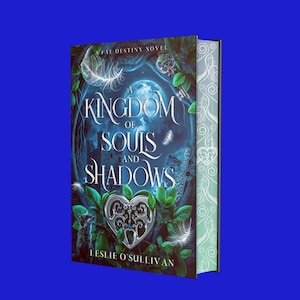 May include: A fantasy novel book cover with a blue and green background. The title is "A Kingdom of Souls and Shadows" with a silver heart-shaped keyhole in the center. The author is Leslie O'Sullivan.