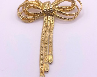 Broche coquette vintage dorée avec nœud