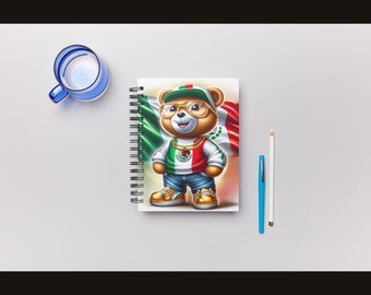 May include: A spiral bound notebook with a colorful illustration of a teddy bear wearing a baseball cap, sunglasses, and a necklace. The bear is standing in front of a Mexican flag.