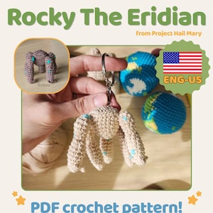May include: A crocheted keychain featuring a beige creature with blue accents, labeled "Rocky The Eridian." The image includes a small crocheted globe and the text "PDF crochet pattern!" with the American flag.