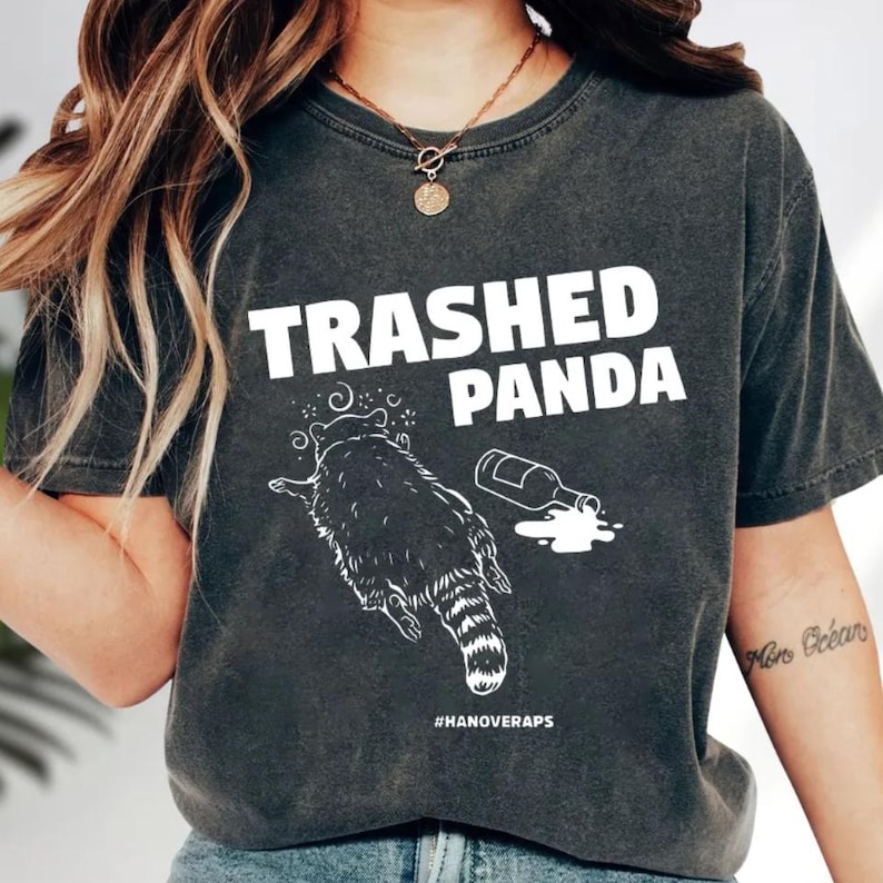 A person wearing a black t-shirt with a graphic design and text printed on it.