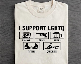 May include: An off-white short-sleeve t-shirt featuring the black text I SUPPORT LGBTQ above five rectangular icons. The icons depict a glass of liquor, a handgun, a beer mug, a pair of breasts, and two figures in a sexual position.