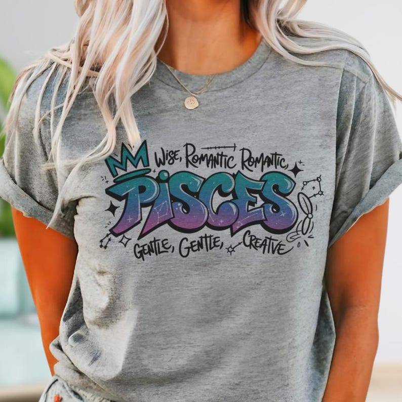 a woman with blonde hair wearing a grey tshirt