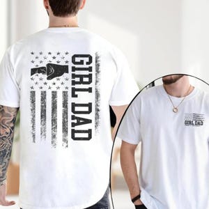 a man wearing a white shirt with a gun on it