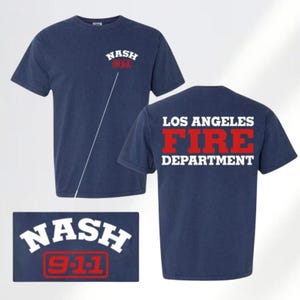 May include: Navy blue t-shirts with white and red text. One shirt has "NASH 911" on the front. The other shirt has "LOS ANGELES FIRE DEPARTMENT" on the back. A rectangular graphic with "NASH 911" is also shown.