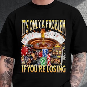 a man wearing a black t - shirt that says it's only a problem
