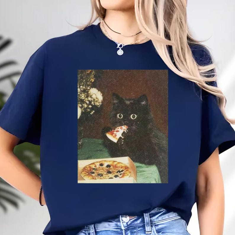 A black cat is eating a pizza from a box, as depicted in the image.