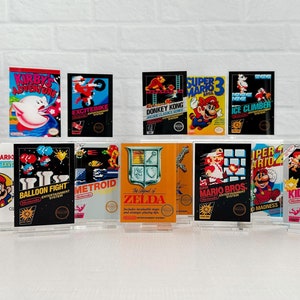 May include: A collection of 10 vintage Nintendo Entertainment System game cartridges, including titles like "Kirby's Adventure", "Excitebike", "Donkey Kong", "Super Mario Bros. 3", "Ice Climber", "Balloon Fight", "Metroid", "The Legend of Zelda", "Super Mario Bros.", "Kid Icarus", and "Super Mario Bros. 2".