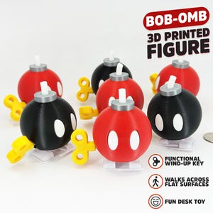 May include: A collection of 3D printed Bob-omb figures in red and black, each featuring white oval eyes, a silver top fuse, and a yellow wind-up key. The figures stand on white feet. Text on the image reads: BOB-OMB 3D PRINTED FIGURE, FUNCTIONAL WIND-UP KEY, WALKS ACROSS FLAT SURFACES, FUN DESK TOY.