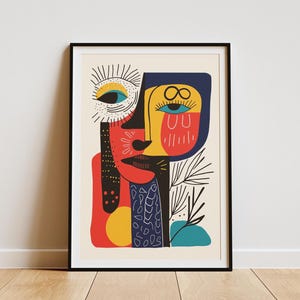 May include: Abstract art print featuring a colorful face with geometric shapes and lines. The face is composed of red, yellow, blue, and black colors. The background is a light beige.