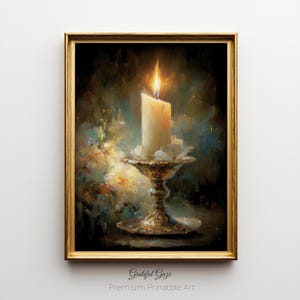 May include: A framed painting of a lit candle in a decorative holder. The candle is ivory, with a bright yellow flame. The holder is gold-toned, with ornate detailing. The background is a dark, textured blend of blues, greens, and golds. The text "Grateful Gaze" and "Premium Printable Art" are at the bottom.