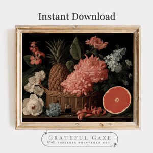 May include: A vintage-style still life print featuring a woven basket overflowing with a pineapple, pink and white flowers, and a grapefruit half. The artwork is set against a dark background and framed in a gold-colored frame. Text reads "Instant Download" and "Grateful Gaze Timeless Printable Art."