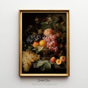 May include: A framed still life painting featuring a variety of fruits, including grapes, peaches, and oranges. The fruits are arranged in a decorative bowl and on a dark surface. The frame is gold, and the artwork is labeled "Grateful Gaze Premium Printable Art."