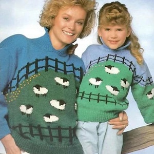 May include: Two matching blue and green sweaters with a sheep design. The sweaters have a blue upper section and a green lower section with a black fence and white sheep. The sweaters are worn by two people.