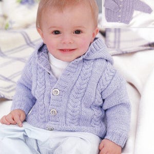 May include: A baby in a light purple hooded cardigan. The cable knit sweater has three buttons and is worn with light blue trousers. A smaller image of the sweater is in the top right corner.