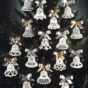 May include: A collection of sixteen white, crocheted bell ornaments with decorative bows. The bells are displayed on a dark green Christmas tree. The bows are silver and gold, adding a festive touch to the handmade decorations.