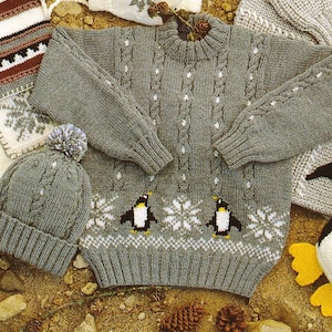 May include: A gray knitted sweater and matching hat with a penguin and snowflake design. The sweater has long sleeves and a crew neck. The hat has a pom-pom on top. The sweater and hat are made of a soft, warm yarn.