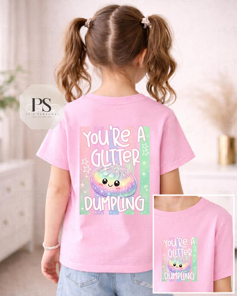 May include: A pink t-shirt featuring the phrase "You're a Glitter Dumpling" and a colourful dumpling graphic. The design includes a rainbow-coloured dumpling with a smiling face, stars, and stripes. A smaller version of the design is on the lower right.