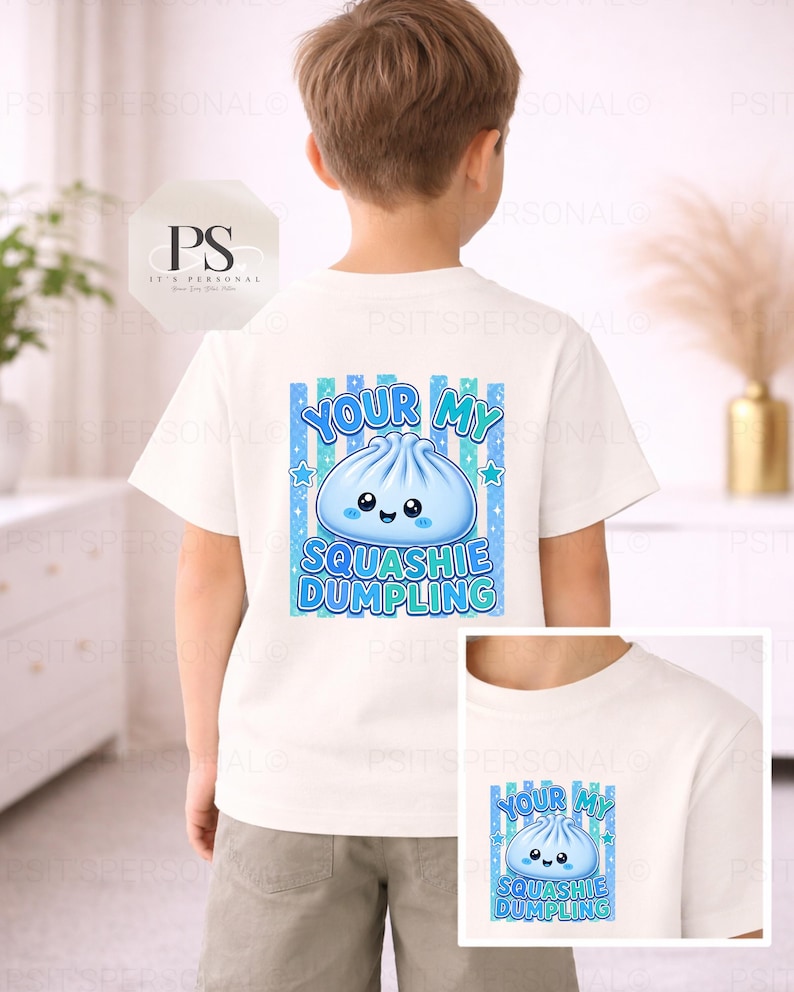 May include: White t-shirt featuring a blue and turquoise dumpling graphic with the words "YOUR MY SQUASHIE DUMPLING". The design includes stars and a striped background. A smaller version of the design is also visible.
