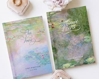 May include: Two rectangular vow books featuring a Monet-inspired water lily painting print. Each book displays the white cursive text Our Vows, the names Stacy & Matthew, and the date 11.9.2026. Two velvet ring boxes hold metallic wedding bands.