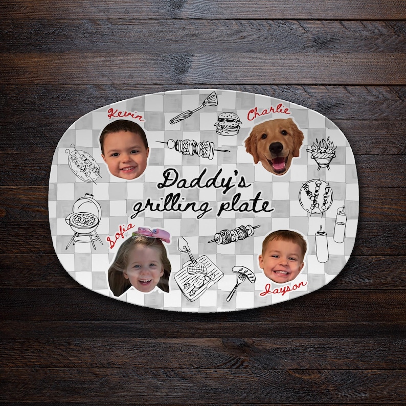 May include: An oval serving plate with a gray and white checkered pattern. It features the text "Daddy's grilling plate" in black script, surrounded by black line drawings of grilling tools, food, and photos of two children and a dog.