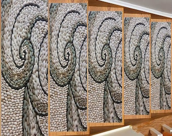 May include: A wall covered in five wooden panels, each featuring a swirling pattern made of small, white, gray, and green stones. The panels are arranged in a staggered pattern, creating a dynamic visual effect.
