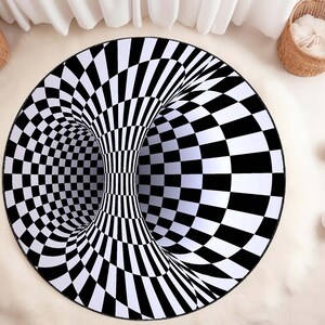 May include: A black and white checkered round rug with a 3D optical illusion of a tunnel. The rug is on a white fluffy surface.