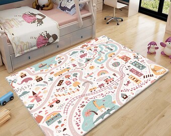 May include: A white play mat with a pink road winding through a colorful town with houses, trees, animals, and vehicles. The mat is perfect for imaginative play and learning.