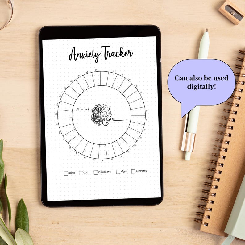 May include: A black and white printable anxiety tracker on a tablet. The tracker is a circle with a brain graphic in the center. The text "Anxiety Tracker" is at the top of the page. The text "Can also be used digitally!" is in a speech bubble.