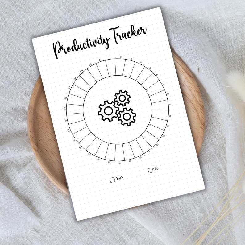 May include: A black and white printable productivity tracker with a circle divided into 30 sections. The center of the circle features a graphic of three gears. The text "Productivity Tracker" is at the top of the page. The words "Yes" and "No" are in checkboxes at the bottom of the page.
