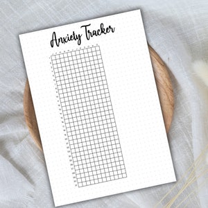 May include: A printable anxiety tracker with a grid of 31 days and 12 months, labeled January through December. The tracker is on a white background with black grid lines and black text.