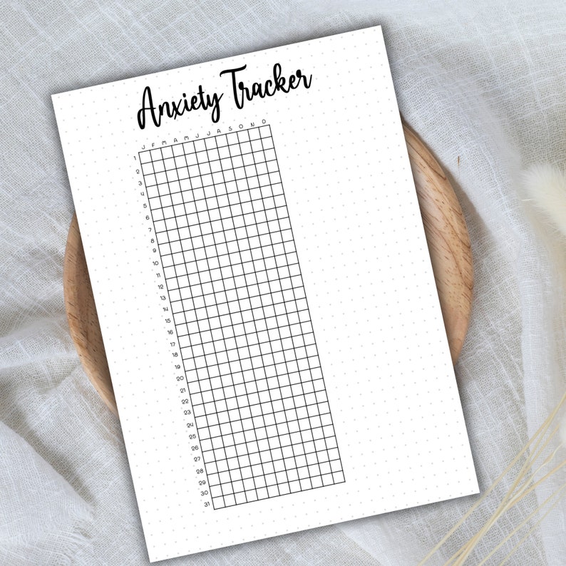 May include: A printable anxiety tracker with a grid of 31 days and 12 months, labeled January through December. The tracker is on a white background with black grid lines and black text.