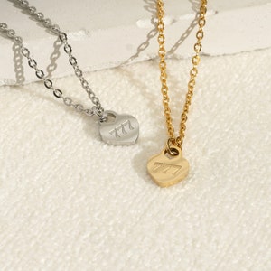 a couple of necklaces sitting on top of a table