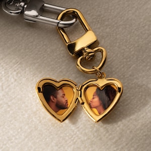 a couple's heart shaped keychain with a picture of a man and