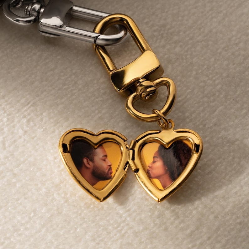 a couple's heart shaped keychain with a picture of a man and