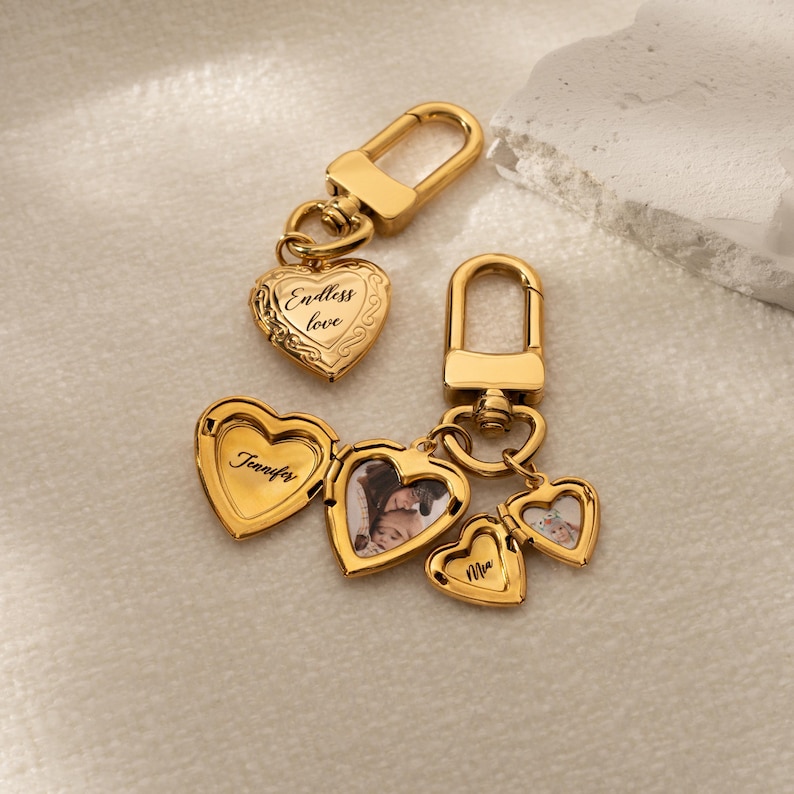 a couple of heart shaped key chains on a white surface