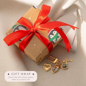 a gift wrapped in brown paper with a red ribbon