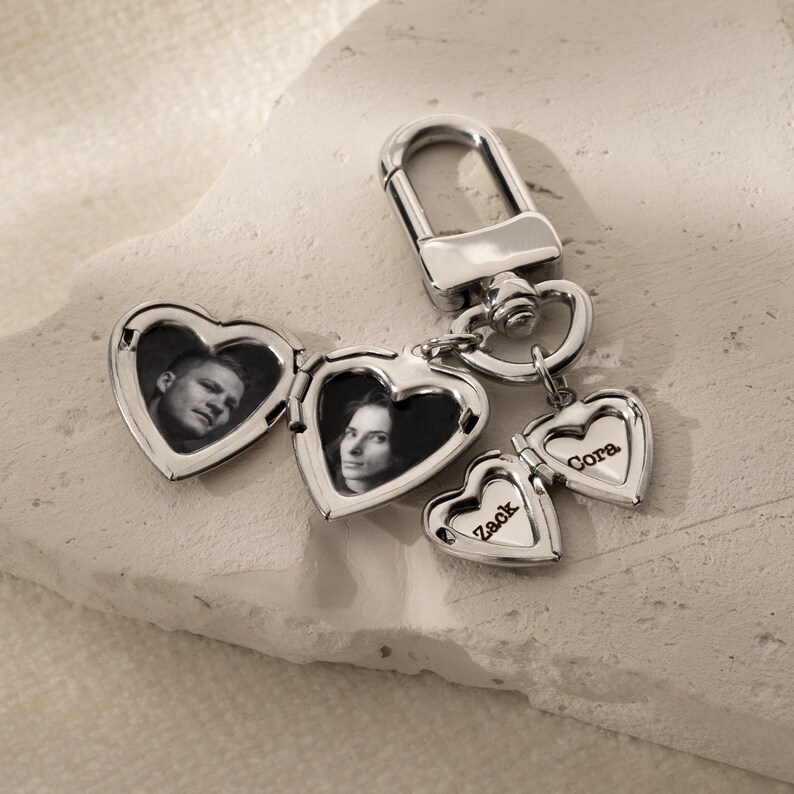a couple of heart shaped key chains with a picture on them