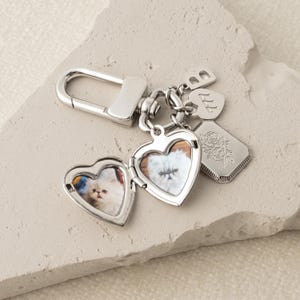 a couple of heart shaped key chains sitting on top of a rock