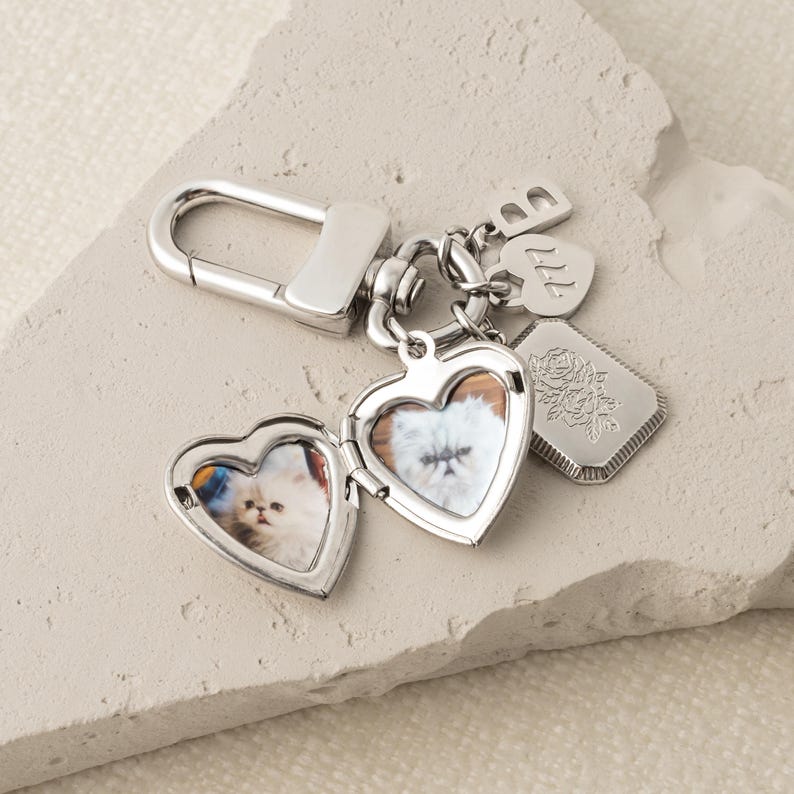 a couple of heart shaped key chains sitting on top of a rock