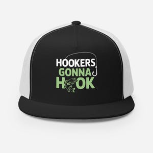 May include: Black and white trucker hat with a green fish graphic and the text "Hookers Gonna Hook" on the front.